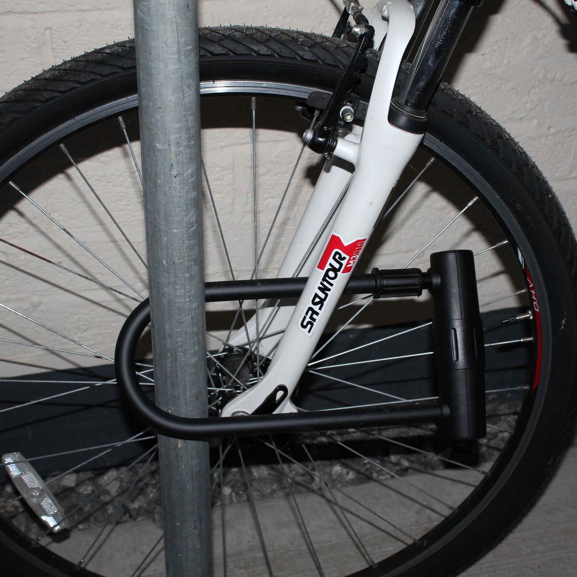 Close-up of sturdy D-shaped bicycle lock showing compact clearance design