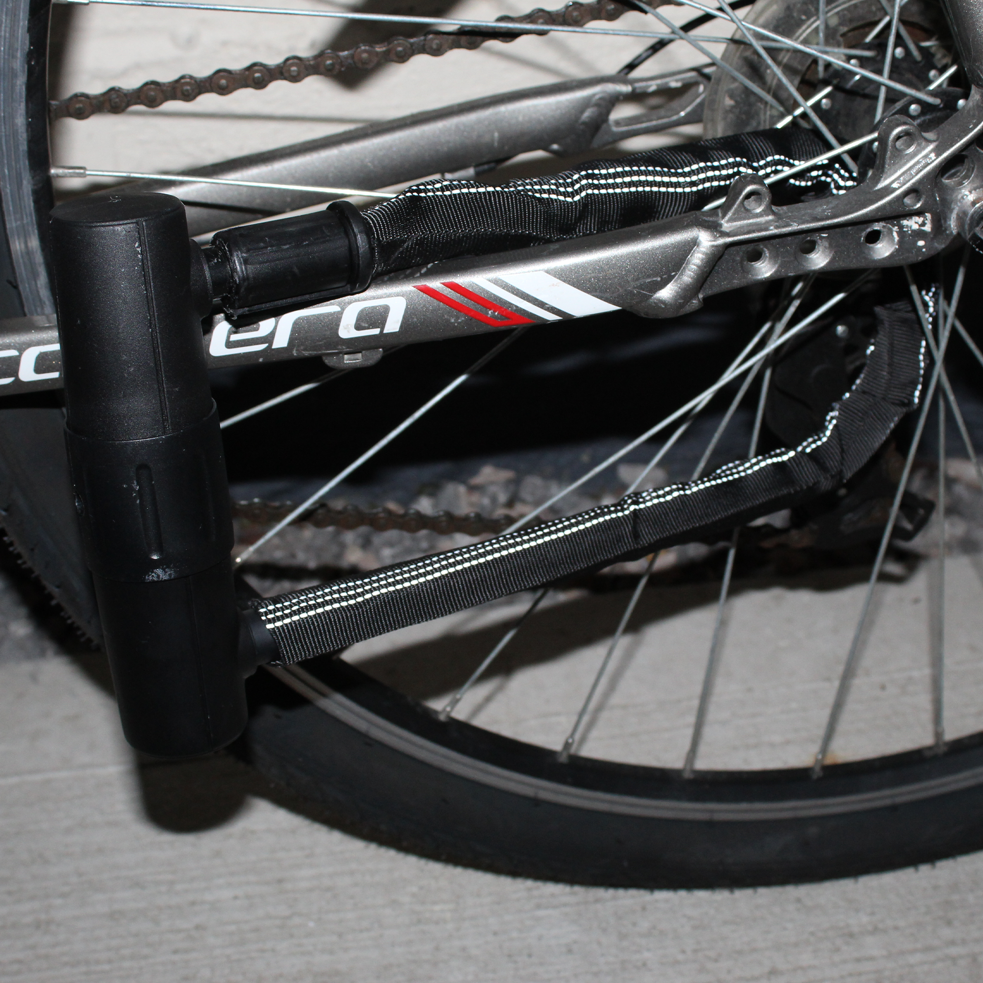 Bicycle lock mounted on frame using a universal carrying bracket