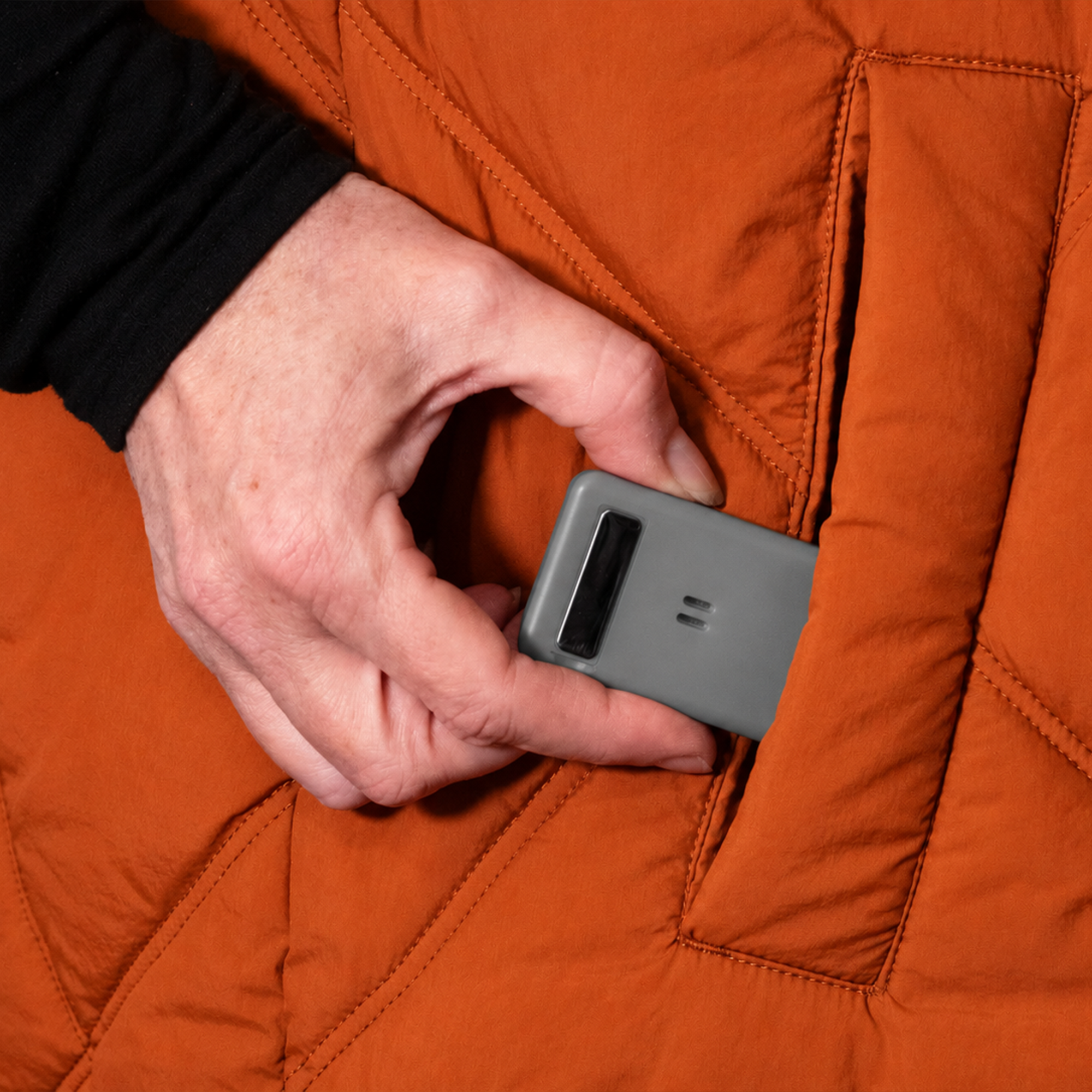 Portable personal alarm with re-usable adhesive backing for easy attachment